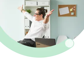 Business professional working on a laptop in a bright office space.