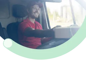 Delivery driver in vehicle using a mobile device for customer-focused logistics operations.