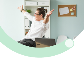 Work-Life Balance: Business professional working on laptop in bright office space representing healthy work-life balance and employee wellbeing